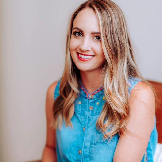 smiling girl in blue sleeveless dress